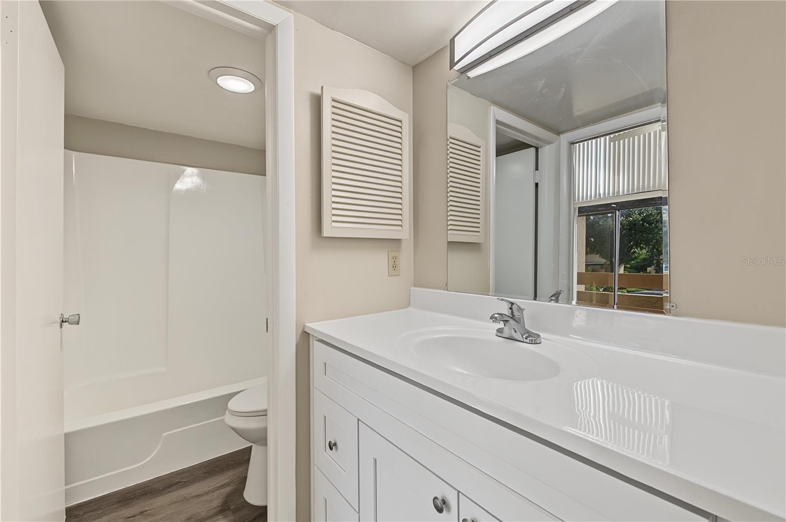 Bathroom, new light fixture and laminate flooring. - 2729 FOXFIRE CT #C, CLEARWATER