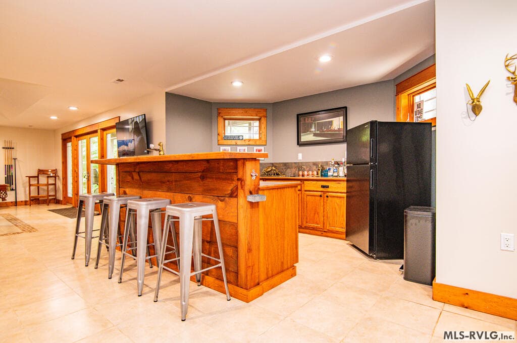 Room to Relax and Unwind, Spacious lower-level living area with a cozy stone fireplace, comfortable gathering space and plenty of room for movie nights after a day on the lake. - 243 Woodland Rd, Littleton NC 27850, Littleton