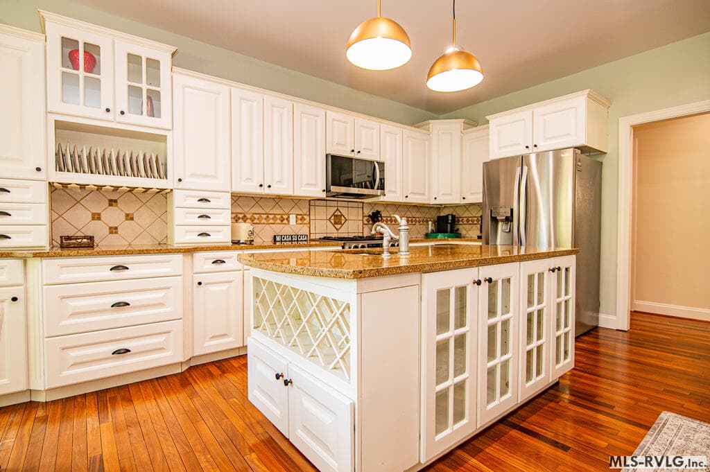 Open & Inviting , Breakfast bar connects the kitchen and living areas, creating an easy flow for casual meals, conversation and entertaining. - 243 Woodland Rd, Littleton NC 27850, Littleton
