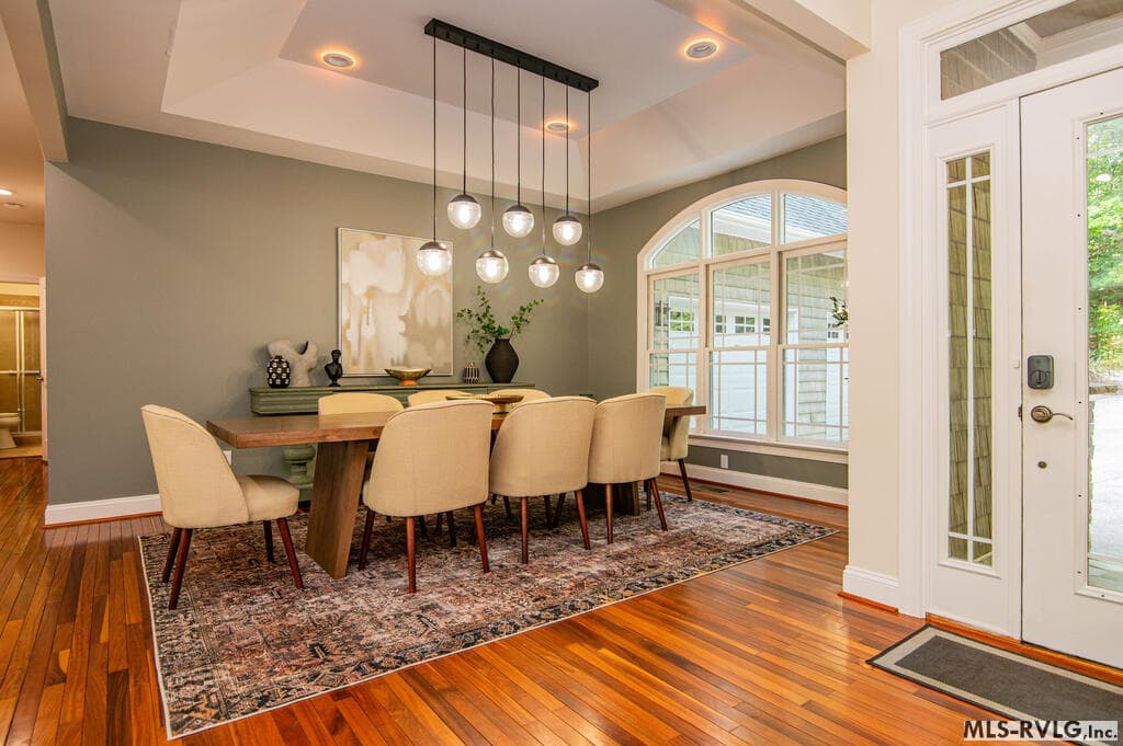 Stunning Great Room, Stunning great room with soaring vaulted ceilings, dramatic stone gas fireplace, hardwood floors and expansive windows overlook the wooded setting. - 243 Woodland Rd, Littleton NC 27850, Littleton