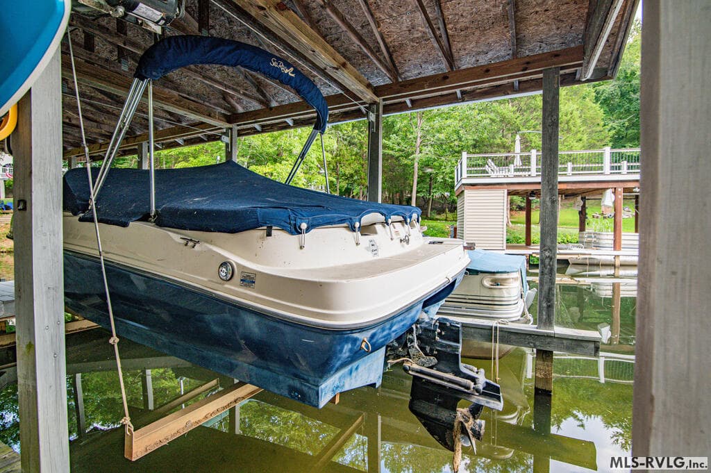 Indoor-Outdoor Living , The great room opens directly onto this expansive deck with a large dining table and plenty of seating—perfect for entertaining and enjoying lake life with family and friends. - 243 Woodland Rd, Littleton NC 27850, Littleton