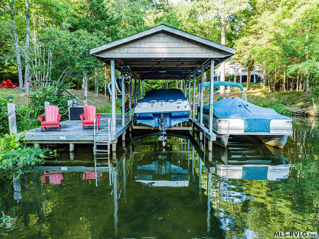 Boathouse, Private covered boathouse with a boat lift and plenty of space for lake toys and watercraft, all included with the purchase of this property. - 243 Woodland Rd, Littleton NC 27850, Littleton