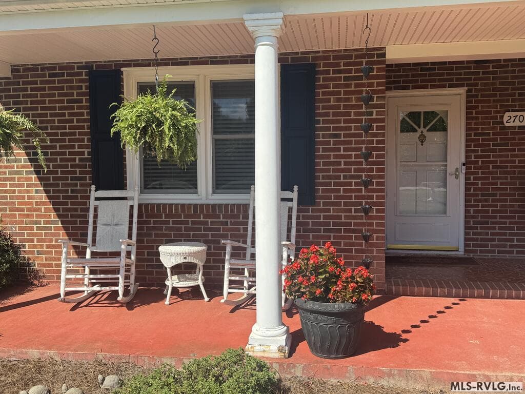 Front Porch, Covered porch with rocking chairs (Rocking chairs do not convey) invite you to come sit on the front porch and talk with neighbors and friends, like we did in days gone by! - 2709 Ankum Rd., Gasburg VA 23857, Gasburg
